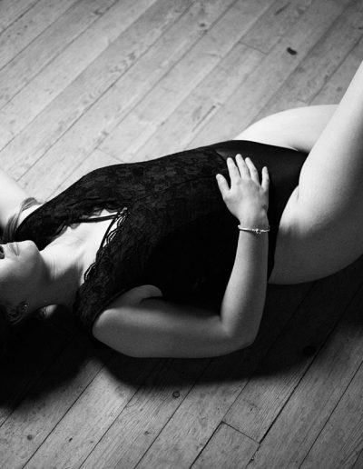 Women lying on the wooden floor black and white image - Sun is gaving over her